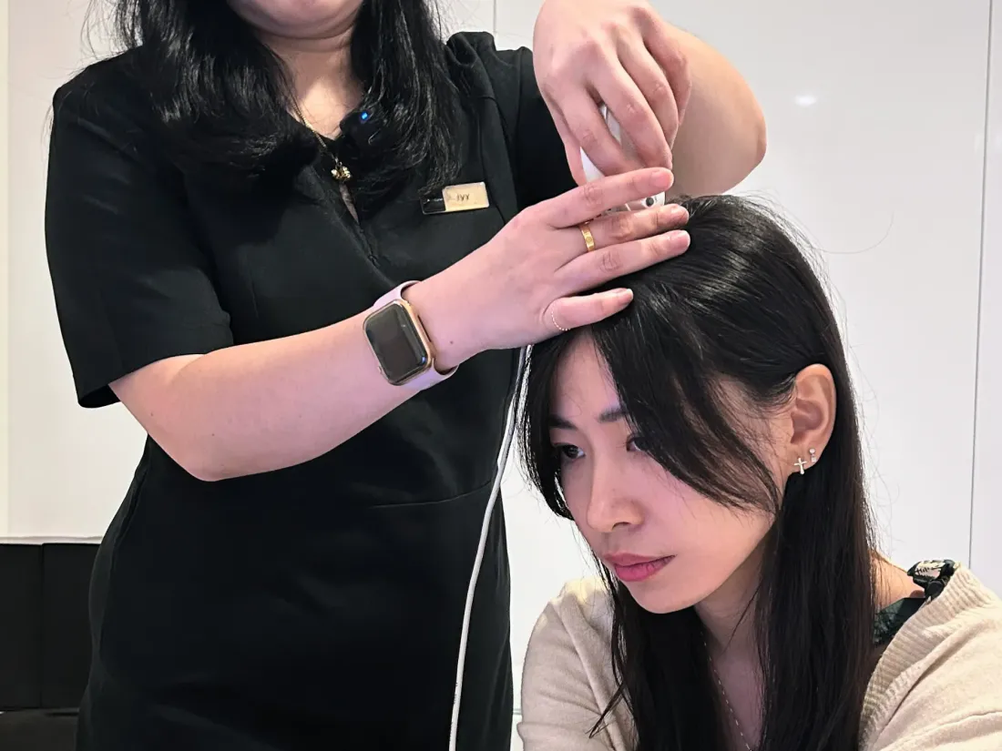 Trichologist performing scalp analysis before starting the Hair Revival Program