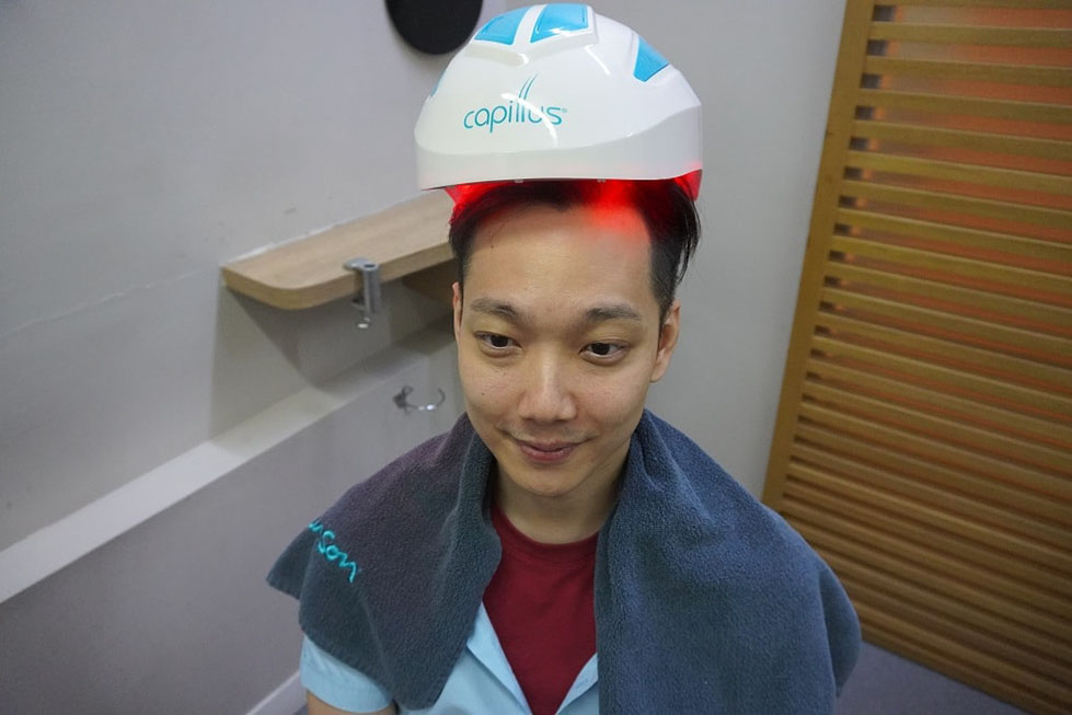 A patient under the Capillus machine
